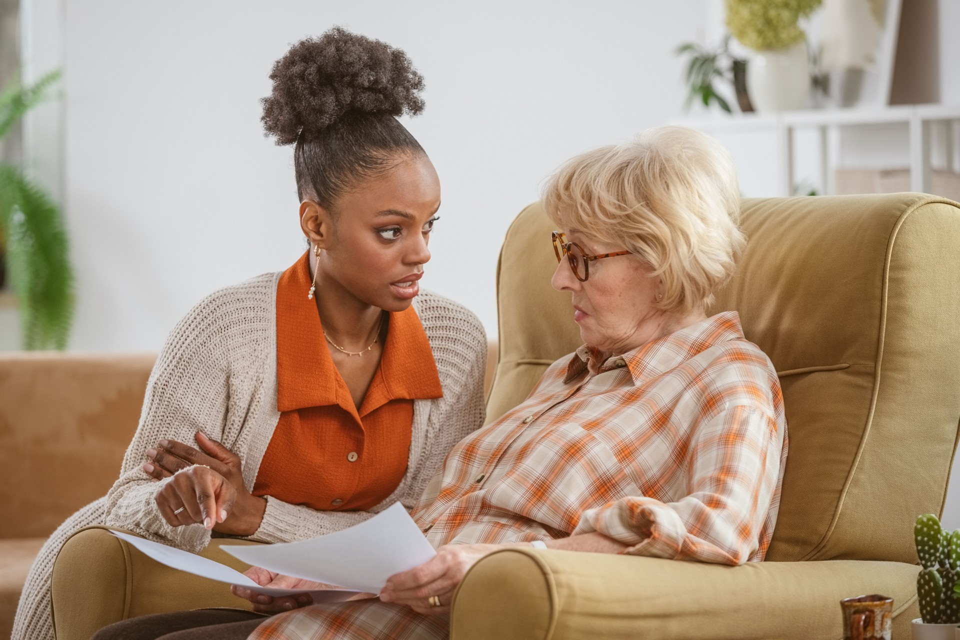 Home caregiver taking care of senior woman
